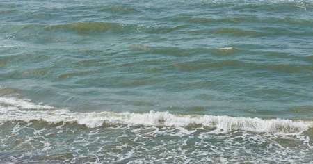 Baltic sea shore. Waves and water splashes, foam. Seascape. Europe. Fickle weather, climate change,...