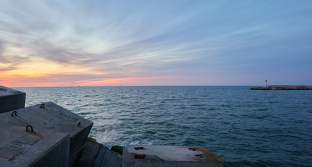 Baltic sea after the storm. Breakwaters. Dramatic sky, glowing clouds, soft sunlight, midnight sun....