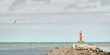 Baltic sea shore (sand dunes, beach). Dramatic sky, glowing clouds. Promenade to the lighthouse,...