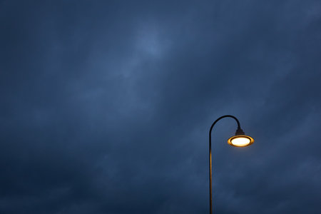 Street lantern. Dramatic sky, dark storm clouds. Empty street at night. Concept urban scene....