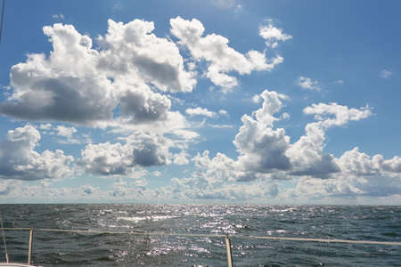 Baltic sea on a sunny summer day. Clear blue sky, glowing clouds.Panoramic view from a sailing boat. Nature, climate change, weather, cruise, recreation themesの写真素材