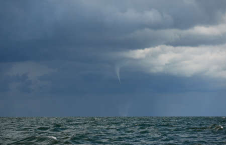 Baltic sea under dramatic clouds during thunderstorm. Panoramic view from a sailing boat. Epic seascape. Cyclone, gale, storm, tornado, rough weather, meteorology, climate change, natural phenomenonの写真素材