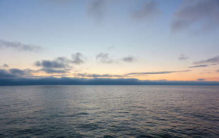 Baltic sea at sunset. Dramatic sky, glowing clouds, soft sunlight, midnight sun. Twilight, summer night. Picturesque dreamlike seascape, cloudscape, nature. Panoramic viewの写真素材