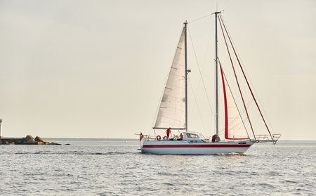 Modern two masted sailboat sailing in the Baltic sea on a clear day. Transportation, yacht cruise,...