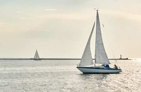 White sloop rigged yacht sailing in the Baltic sea on a clear day. Transportation, cruise, yachting, regatta, sport, recreation themes. Travel, exploring, wanderlust conceptsの写真素材