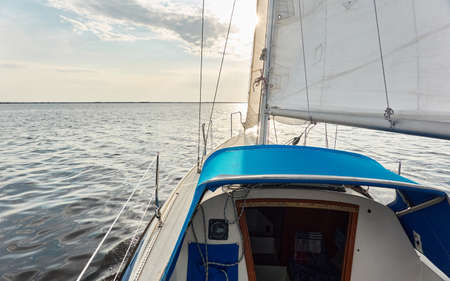 White sloop rigged yacht sailing in the Baltic sea after the storm. Waves, splashes, water surface. Cruise, summer vacations, regatta, sport, leisure activity, tourism, wanderlust conceptsの写真素材