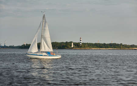 White sloop rigged yacht sailing in the Baltic sea on a clear day. Transportation, cruise, yachting, regatta, sport, recreation themes. Travel, exploring, wanderlust conceptsの写真素材