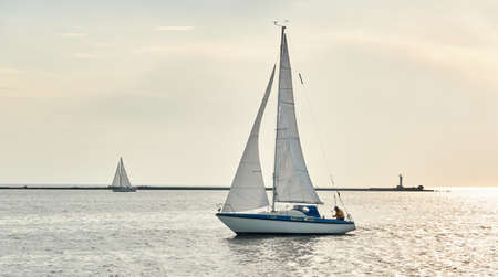 White sloop rigged yacht sailing in the Baltic sea on a clear day. Transportation, cruise, yachting, regatta, sport, recreation themes. Travel, exploring, wanderlust conceptsの写真素材