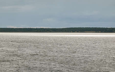 Muhu strait, Estonia, Baltic sea. Dramatic sky, storm clouds, water surface texture. Panoramic view. Nature, eco tourism, weather themes;の写真素材