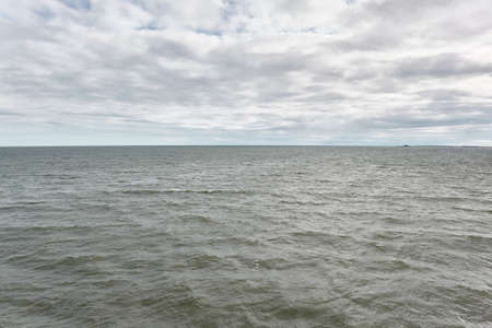 Muhu strait, Estonia, Baltic sea. Dramatic sky, storm clouds, water surface texture. Panoramic view. Nature, eco tourism, weather themes;の写真素材