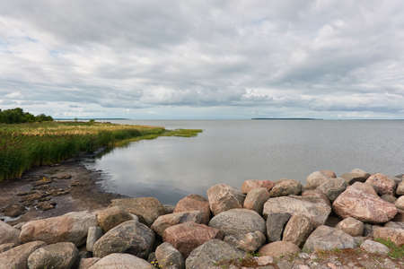 Panoramic view from the rocky sea shore. Dramatic sky. clouds. Kuivastu harbour, Estonia. Nature, eco tourism, wanderlust, summer vacation conceptsの写真素材
