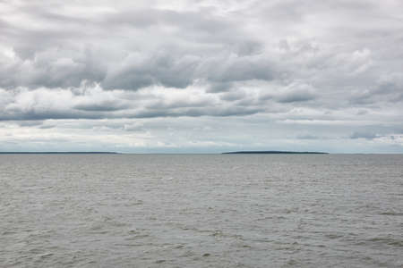 Muhu strait, Estonia, Baltic sea. Dramatic sky, storm clouds, water surface texture. Panoramic view. Nature, eco tourism, weather themes;の写真素材