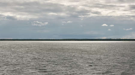 Muhu strait, Estonia, Baltic sea. Dramatic sky, storm clouds, water surface texture. Panoramic view. Nature, eco tourism, weather themes;の写真素材