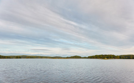 Majestic evergreen forest and Suiro lake (Kulovesi). Finland. Scandinavia, Europe. Reflections in a still water, clear sky. Autumn landscape. Nature, seasons, ecotourism, peace and harmony conceptsの写真素材