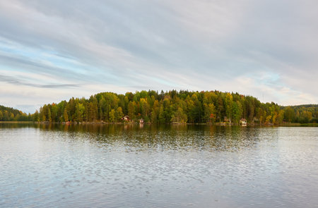 Majestic evergreen forest and Suiro lake (Kulovesi). Finland. Scandinavia, Europe. Reflections in a still water, clear sky. Autumn landscape. Nature, seasons, ecotourism, peace and harmony conceptsの写真素材