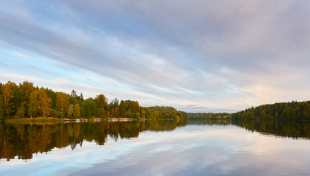 Majestic evergreen forest and Suiro lake (Kulovesi). Finland. Scandinavia, Europe. Reflections in a still water, clear sky. Autumn landscape. Nature, seasons, ecotourism, peace and harmony conceptsの写真素材