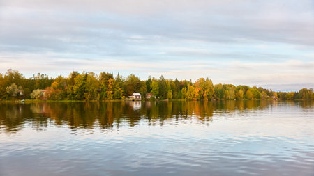 Majestic evergreen forest and Suiro lake (Kulovesi). Finland. Scandinavia, Europe. Reflections in a still water, clear sky. Autumn landscape. Nature, seasons, ecotourism, peace and harmony conceptsの写真素材