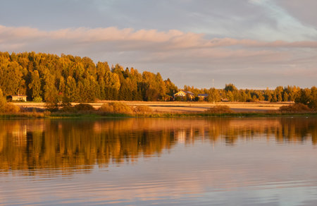 Country house (cottage) on the lakeshore. Forest in the background. Sunset. Autumn. Suiro lake (Kulovesi), Finland. Panoramic view. Pure nature, ecotourism, remote places conceptsの写真素材