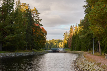 River (canal) in a forest park. Promenade, pier and walking area. Early autumn landscape. Finland. Nature, environment, eco tourism themesの写真素材
