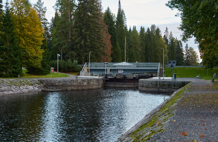 River (canal) in a forest park. Promenade, pier and walking area. Early autumn landscape. Finland. Nature, environment, eco tourism themesの写真素材