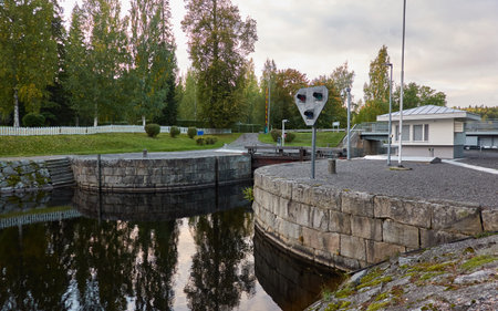 River (canal) in a forest park. Promenade, pier and walking area. Early autumn landscape. Finland. Nature, environment, eco tourism themesの写真素材