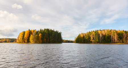 Panoramic view of the rocky forest lake shore on a sunny day. Autumn landscape. Finland, Finnish nature. Ecology, fresh air, ecotourism themesの写真素材