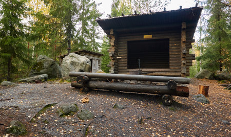 Lean-to shelter (or Finnish Laavu), traditional wooden building (log cabin) and resting zone in the middle of the evergreen pine forest. Lapland, Finland. Nature, ecotourism, weekend getaway conceptsの写真素材