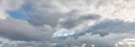 Ornamental clouds. Dramatic sky. Epic storm cloudscape. Soft sunlight. Panoramic image, texture, background, graphic resources, design, copy space. Meteorology, heaven, hope, peace conceptの写真素材