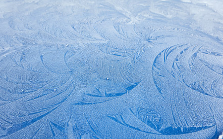 picturesque ice pattern. Winter wonderland and Christmas magic concepts. Frozen water surface, glass or view from the window. Environment, nature, ecology, cold weather, climate change themesの写真素材
