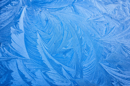picturesque ice pattern. Winter wonderland and Christmas magic concepts. Frozen water surface, glass or view from the window. Environment, nature, ecology, cold weather, climate change themesの写真素材