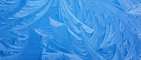 picturesque ice pattern. Winter wonderland and Christmas magic concepts. Frozen water surface, glass or view from the window. Environment, nature, ecology, cold weather, climate change themesの写真素材