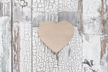 Paper heart on a rustic wall, door as a symbol of loveの写真素材
