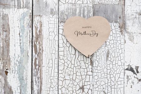 Happy Mother's Day written on a paper card on a rustic old wall, doorsの写真素材