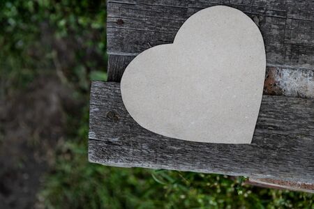Paper heart on an old bench as a symbol of loveの写真素材