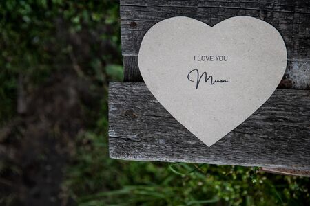 I love You Mum written on a paper card on a rustic old benchの写真素材