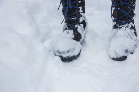 Black boots on the snow.の写真素材