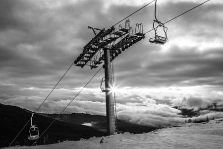 Black and white mountains landscape with ski lift. Sunrise over Carpathian mountain in Ukraine.の写真素材