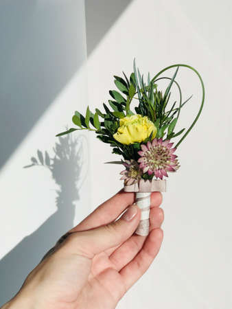 Closeup of elegant stylish male accessories isolated on white background. Preparation for wedding concept. Vertical color photo.の写真素材
