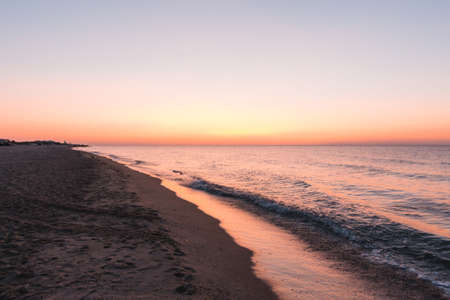 Pink sunset on the ocean or sea beachの写真素材