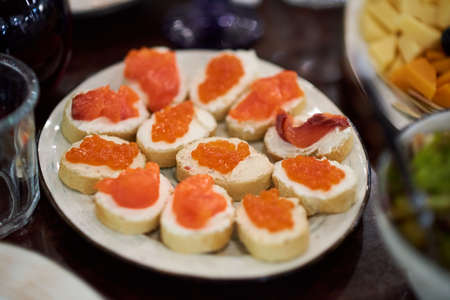 Small appetizers with red caviar and fishの写真素材