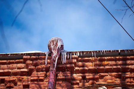 Icicles on rooftops on a sunny February day
