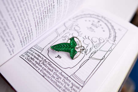 Astrakhan, Russia - 03.26.2021: Green brooch on Lord of the Rings bookのeditorial素材