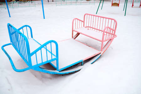 Double swing balancers for childrent with blue and pink seats for boys and girlsの写真素材