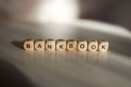 Bankbook word is made with wooden cubesの写真素材