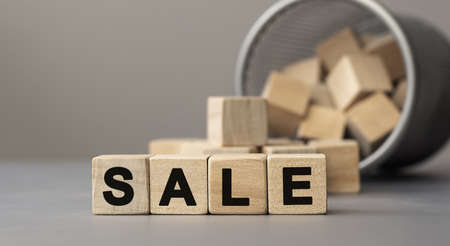 Word SALE made with cube wooden block on a desk.の写真素材