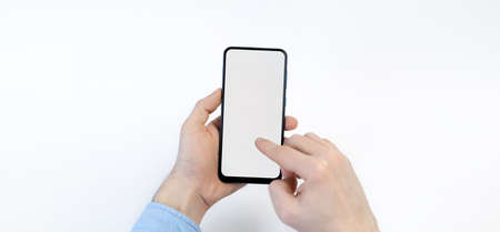 Male hands holding smartphone with blank screen on white background