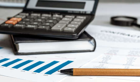 Calculator on financial papers at the table close up. Finance conceptの写真素材