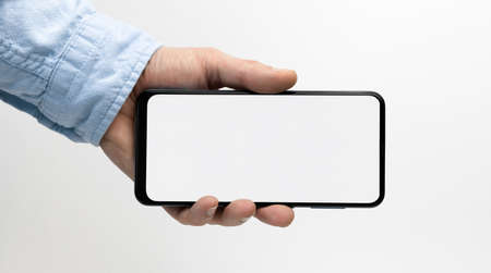 Male hand holding smartphone with blank screen on white backgroundの写真素材