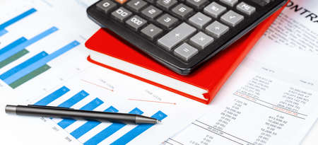 Calculator on financial papers at the table close up. Finance conceptの写真素材