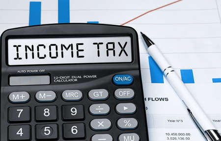 Word INCOME TAX on calculator. Business and tax concept. Stock photoの写真素材